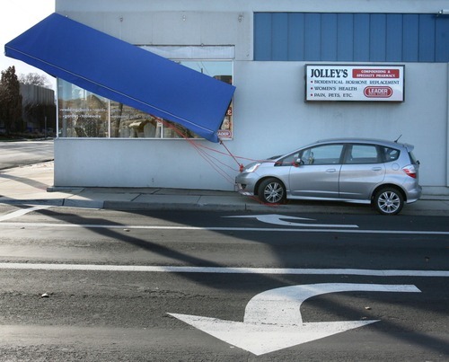 Steve Griffin  |  The Salt Lake Tribune
An awning at Jolley's Corner Pharmacy in Salt Lake City is tied to a car on Thursday to prevent it from blowing away.